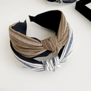 Close-up of French retro striped headbands with brown and salt-blue fabric textures