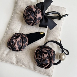 Detailed set of leopard print rose hair clips and hair tie with pearls and velvet bows