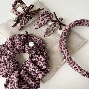 Purple leopard print hair accessory set with scrunchie, hair claw, and bow headband