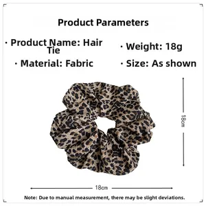 Detail view of large leopard print fabric scrunchie with 18cm diameter and 18g weight spec