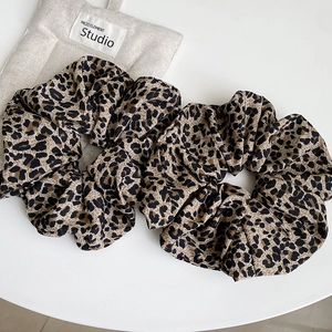 Retro leopard print scrunchie set in coffee brown tones with soft pleated fabric textures