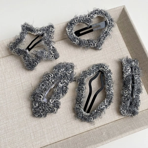 Set of 5 minimalist grey plush hair clips with star and heart shapes in a display tray