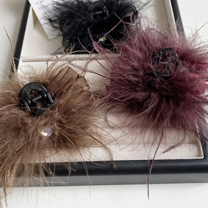 Detailed view of 7cm feather hair claws with sparkling rhinestones in three colors