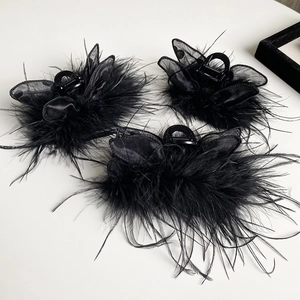 Three elegant black feather and polka dot mesh butterfly hair claws for elegant evening styling