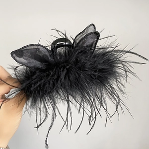 Detailed close-up of the black feather and lace mesh hair claw clip for elegant styling