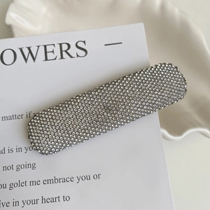 Macro detail of luxury rhinestone rectangle hair clip with shimmering crystals