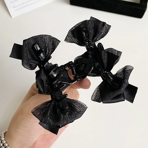 Pince à cheveux élégante avec nœud en maille noire et paillettes pour chignons sophistiqués