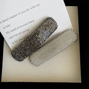 Elegant rhinestone barrette hair clips in silver and dark gray on aesthetic background
