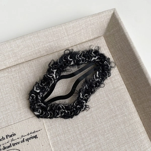 Detailed view of the wavy plush lamb wool fabric texture on a fashion BB hair clip