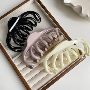 Three-piece set of cream octopus hair claws in black, pink, and white resin colors