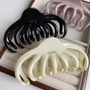 Three-piece hair claw clip set in black, cream white and pink with French branding