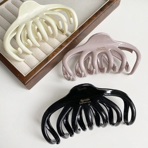 Three-piece large octopus hair claw clips in cream, purple and black resin colors