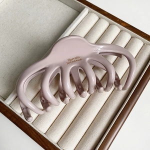 Detail of pink octopus hair claw clip with glossy finish and Barrette LaFrance text