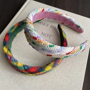 Detail of colorful plaid fabric and braided hemp rope textures on padded headbands