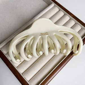 Elegant cream octopus hair claw clip with Barrette La France text for French style updo