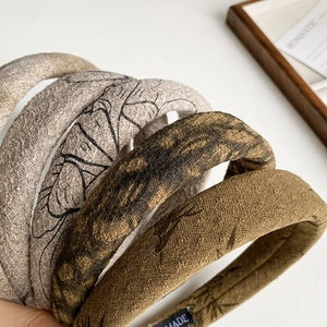 Macro detail of textured linen headbands with ink print and handmade label