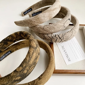 Detailed view of handmade vintage sponge headbands with ink print and cotton linen texture