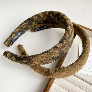 Detail of vintage ink print sponge headbands showing handmade labels and fabric texture
