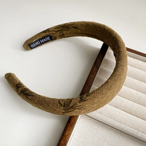 Close-up of ink wash bamboo pattern headband with a woven HAND MADE interior label