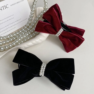 Detail showing velvet bow hair clips with double row pearls in black and wine red