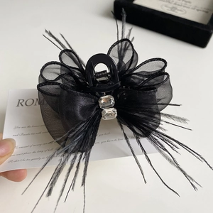 Elegant black feather lace bow hair claw clip with crystal accents on a white background