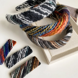 Detailed view of woven wool headbands and hair clips in vintage plaid tweed texture