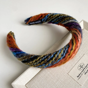 Detail of colorful hand woven wool headband with unique vintage knit pattern and soft texture