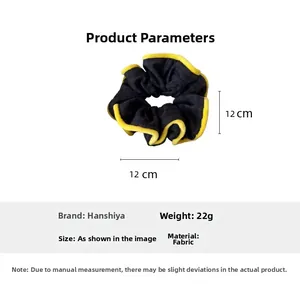 Detail view of a 12cm dark plaid fabric scrunchie with yellow ruffled edge stitching