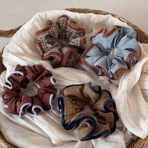Set of four stylish plaid and striped fabric scrunchies in warm earthy brown tones