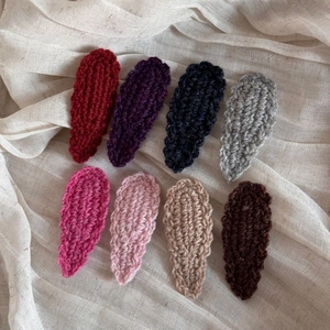 Detailed macro view of 8 colorful handmade wool knitted wave edge water drop hair clips