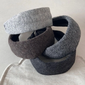 Padded knitted wide headbands in grey and charcoal colors with textured wool fabric
