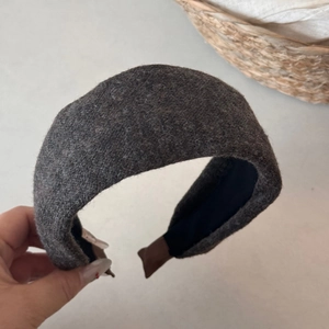 Detail showing high-top thick dark grey knitted wide headband with premium matte wool texture
