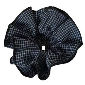 Oversized black and grey plaid scrunchie with layered fabric design and piped edges