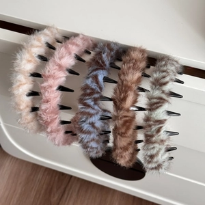 Set of five plush faux fur claw clips with teeth in beige, pink, and brown color variants