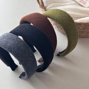 Detail showing textured wool-blend headbands in dark grey, black, coffee, and olive green
