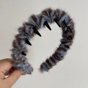 Detail of plush wavy headband with blue and brown stripes showing the inner hair teeth