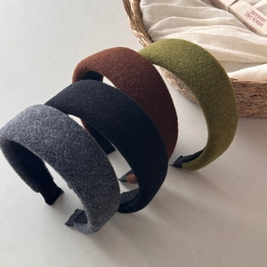 Detail of wool felt headbands in deep grey, black, coffee, and olive green colors