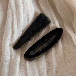 Close-up of vintage striped fabric wrapped hair clips with black metal BB base