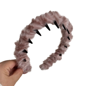 Fuzzy pink plush headband with wavy design and inner teeth for high skull top look