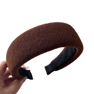Brown wool padded headband with wide brim and plush texture for a chic autumn look