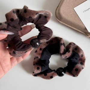 Detail of plush polka dot hair scrunchies with decorative beads for autumn styles