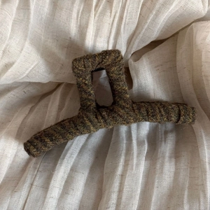 Close-up of vintage striped tweed fabric wrapping on a large hair claw clip for women
