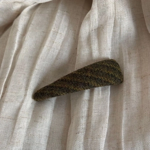 Close-up of vintage striped tweed fabric texture on a large claw clip accessory