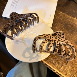 Détail de grandes pinces à cheveux léopard marron et beige pour cheveux épais et denses