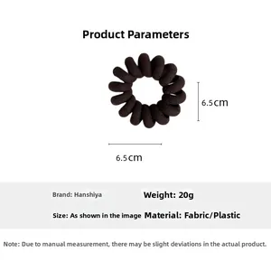 Macro view of coffee brown spiral hair coil with fabric texture and 6.5cm diameter