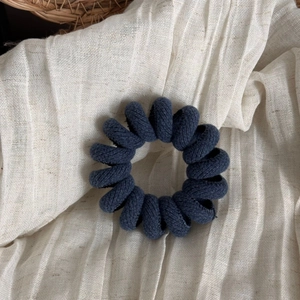 Detail showing high-quality twill fabric texture on a spiral telephone wire hair tie