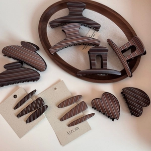 Detailed set of brown marble resin claw clips with white stripes and various heart shapes
