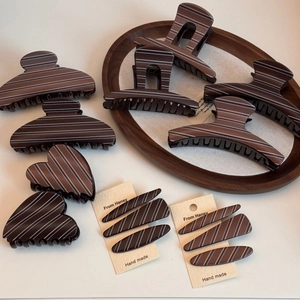 Detailed set of brown striped hair claw clips and barrettes in various vintage shapes