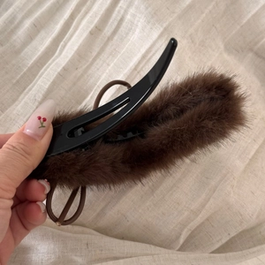 Detailed view of long brown plush duckbill hair clip with soft faux fur texture