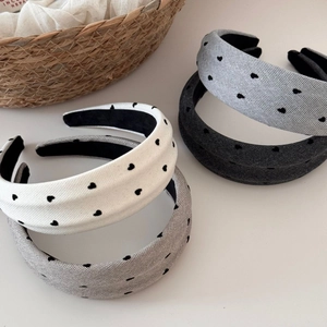 Close-up of heart pattern headbands in various colors with soft fabric texture